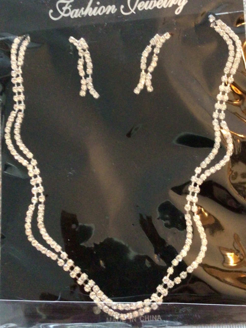 Women’s new in package rhinestone necklace set with pierced earrings